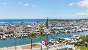 A marina with numerous boats docked, a clear blue sky, and a view of the ocean. - Ilikai Hotel One-Bedroom Suite in a Great Location In Waikiki!  No Resort Fees! (Honolulu)