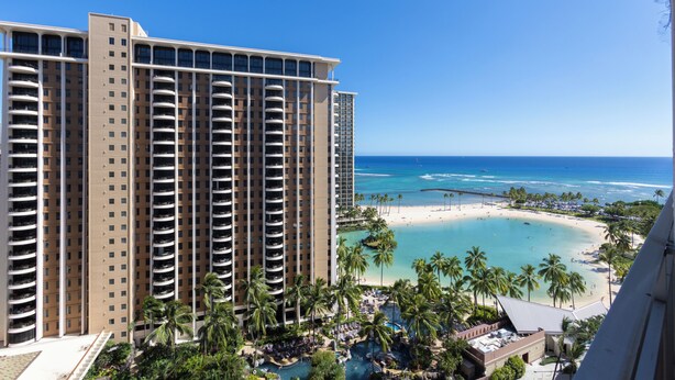 A high-rise hotel with multiple balconies, a beach, and a pool area. - Beautiful Lagoon View At The Ilikai Hotel!  One-bedroom Fully Re-Modeled Unit A++ (Honolulu)