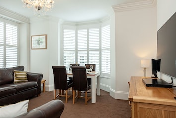 Living area with two large Couches, large Smart TV and family games