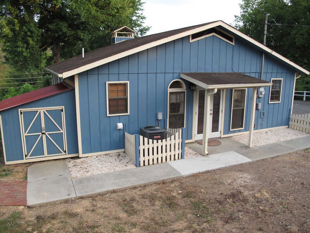 A single-story house with a gabled roof, a front porch, and a small attached garage.