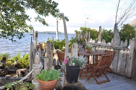 Outdoor dining. A Serene Guest House Perched Right On The Ocean, Pet Friendly, Central.
