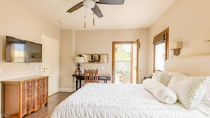 A bedroom with a bed, a ceiling fan, a dresser, a desk, and a chair. - Boutique Luxury in Upscale Area with Private Entry & Bath, Villa A (SAN DIEGO)