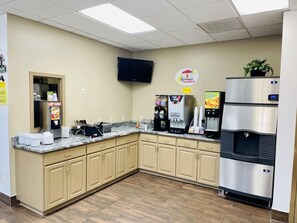 A kitchenette with a microwave, coffee maker, and refrigerator. - super8 clear lake (Clear Lake)