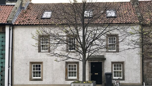A building with a tiled roof, a tree in front, and a bicycle parked outside. - No14 in the heart of St Andrews (St Andrews)