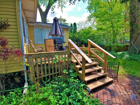 Enjoy al fresco dining on the deck with a grill and comfortable seating.