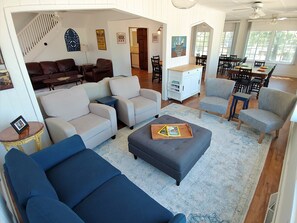 Relax in this inviting living area with a sofa, armchairs, and ottoman, perfect for unwinding.