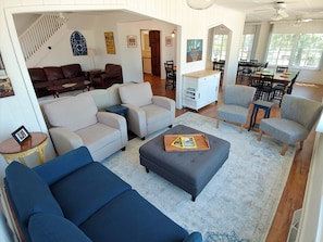 Relax in this inviting living area with a sofa, armchairs, and ottoman, perfect for unwinding.
