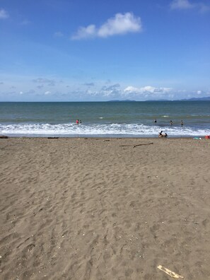 On the beach, black sand