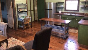 A rustic kitchen with wooden cabinets, a stainless steel refrigerator, and a sink. - 3br2bath farmhouse 7min d'town Mem ❤️1 pet free 2nd pet considered for fee  (Mound City)