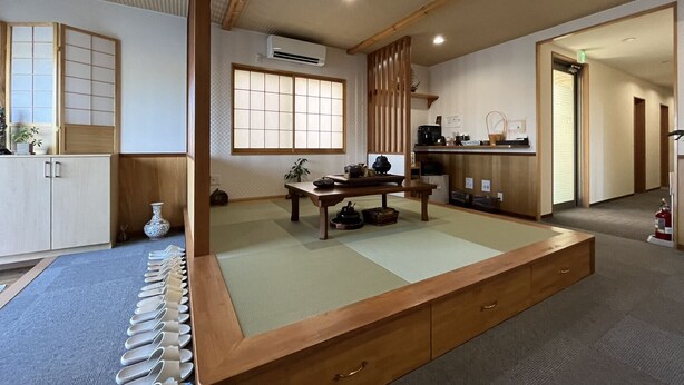 A traditional Japanese room with tatami flooring, a low wooden table, a shoji screen, and a sliding door. - Karin Doo Hotel (Tomisato)