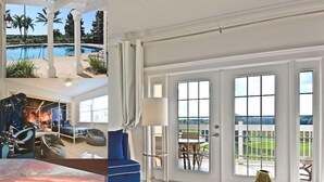 A spacious living room with a large glass table, a blue sofa, and a view of a swimming pool and greenery outside. - Style, Luxury & Stunning Views (Reunion)