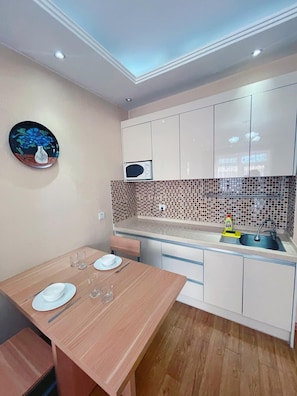 Full-size fridge, microwave, stovetop, rice cooker