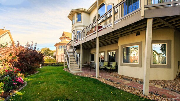 A two-story house with a covered patio, a staircase, and a garden. - Spread out in a large,1600 sq foot comfort suite 1 bedroom plus additional nook (Longmont)