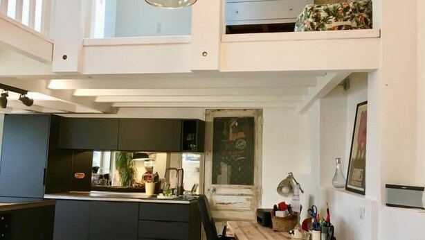 A spacious loft apartment with a blue sofa, a kitchen, and a dining area. - Maisonette with terrace 5 minutes from the beaches (Anglet)