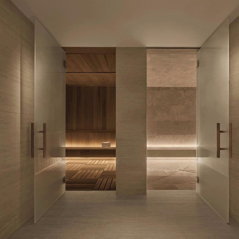 A modern bathroom with a walk-in shower, wooden flooring, and a minimalist design.