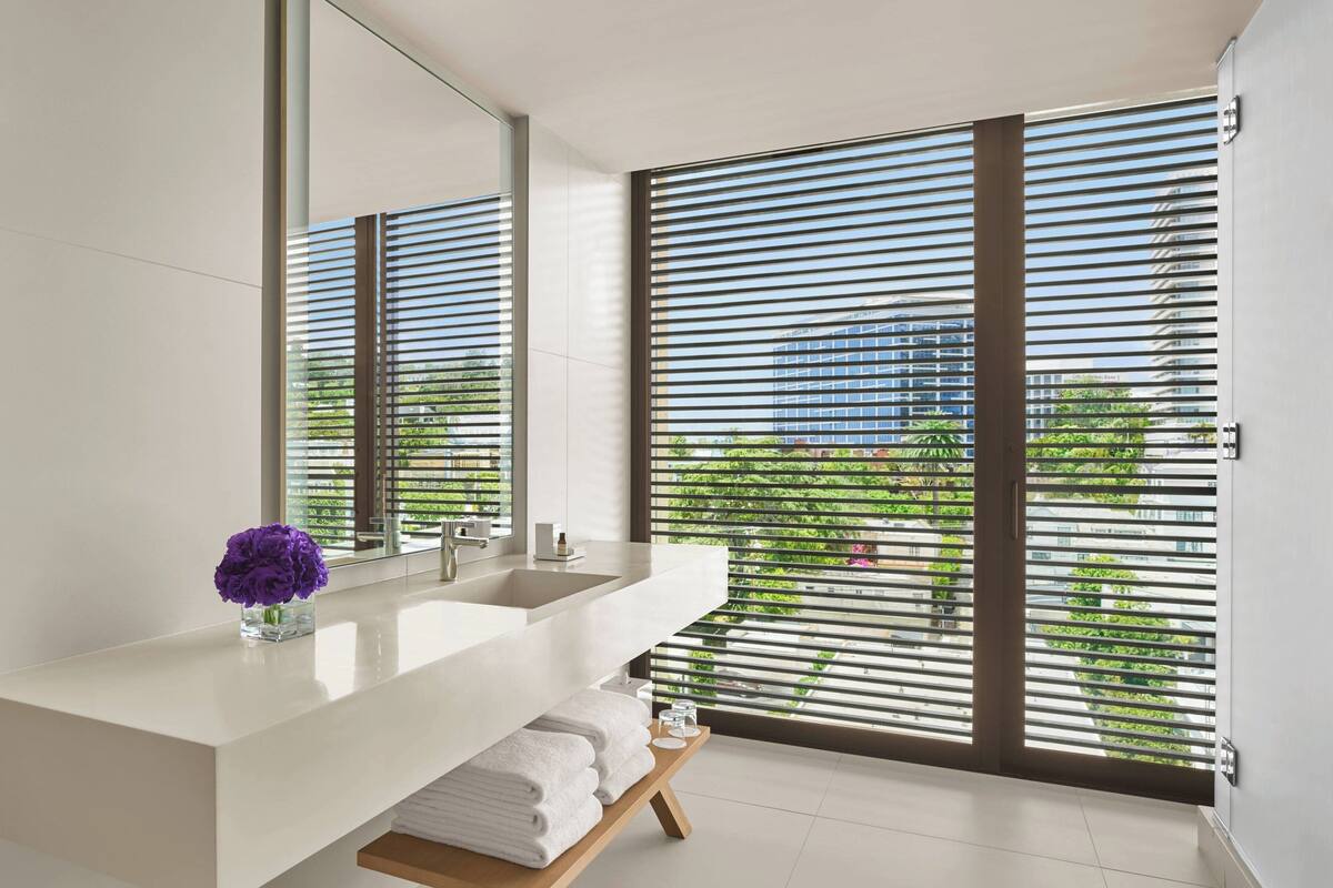 designer toiletries, hair dryer, bathrobes, slippers