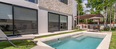 Een buitenzwembad en ligstoelen