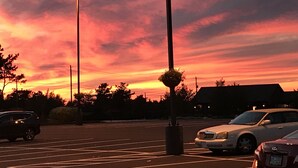 A parking lot with cars and a street lamp.