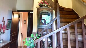 A wooden staircase with a red ceiling and a mirror at the bottom. - Family house in the middle of a green (Le Mont-Saint-Adrien)