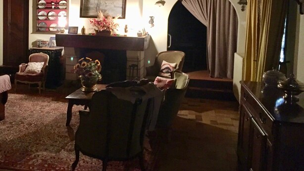 A cozy living room with a fireplace, a dining table, and comfortable seating. - Family house in the middle of a green (Le Mont-Saint-Adrien)