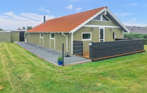 A single-story building with a red-tiled roof, a small porch, and a black fence. - 3 bedroom amazing home in Haderslev (Haderslev)