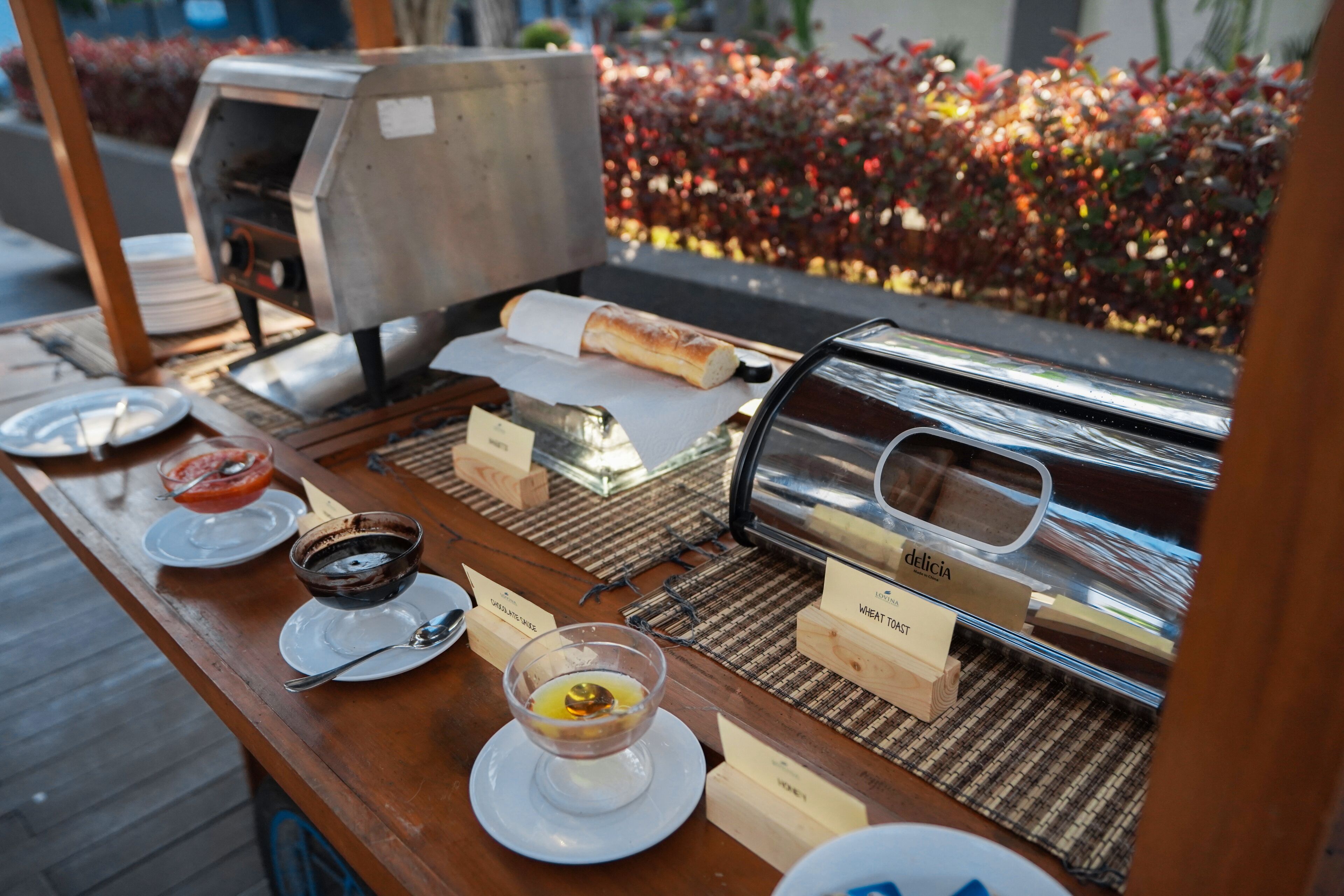 A buffet setup with various food items and a coffee machine.