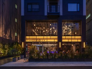 A modern building with a large illuminated sign reading "THE LIVELY". - THE LIVELY OSAKA HONMACHI (Osaka)