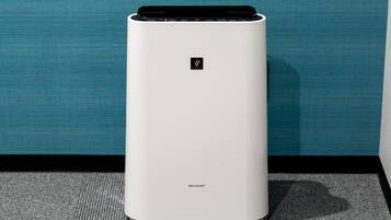 A white, modern air purifier with a control panel and the brand name 'SHARP' visible on the front.