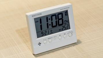A white digital clock displaying the time as 11:08 AM, with a temperature of 25.8°C.