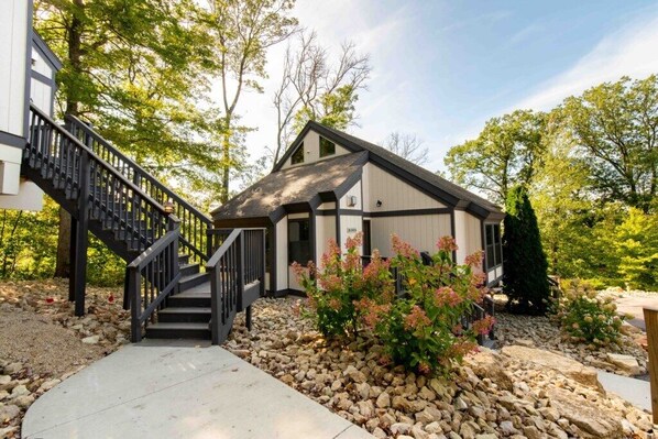 Stunning two-story home with a grand staircase and beautifully manicured garden.