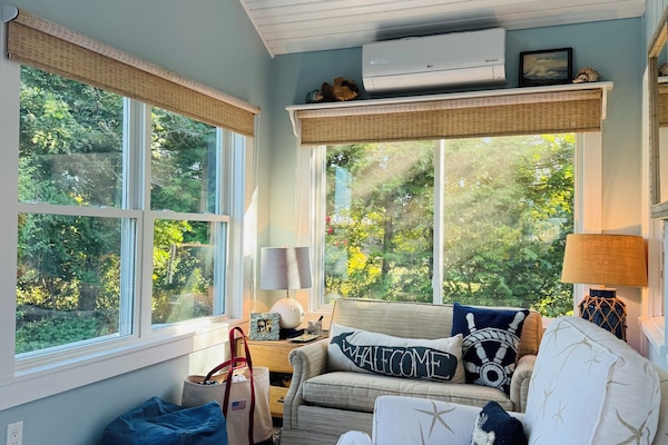 Airy porch seating area with peekaboo ocean views-a great spot for reading