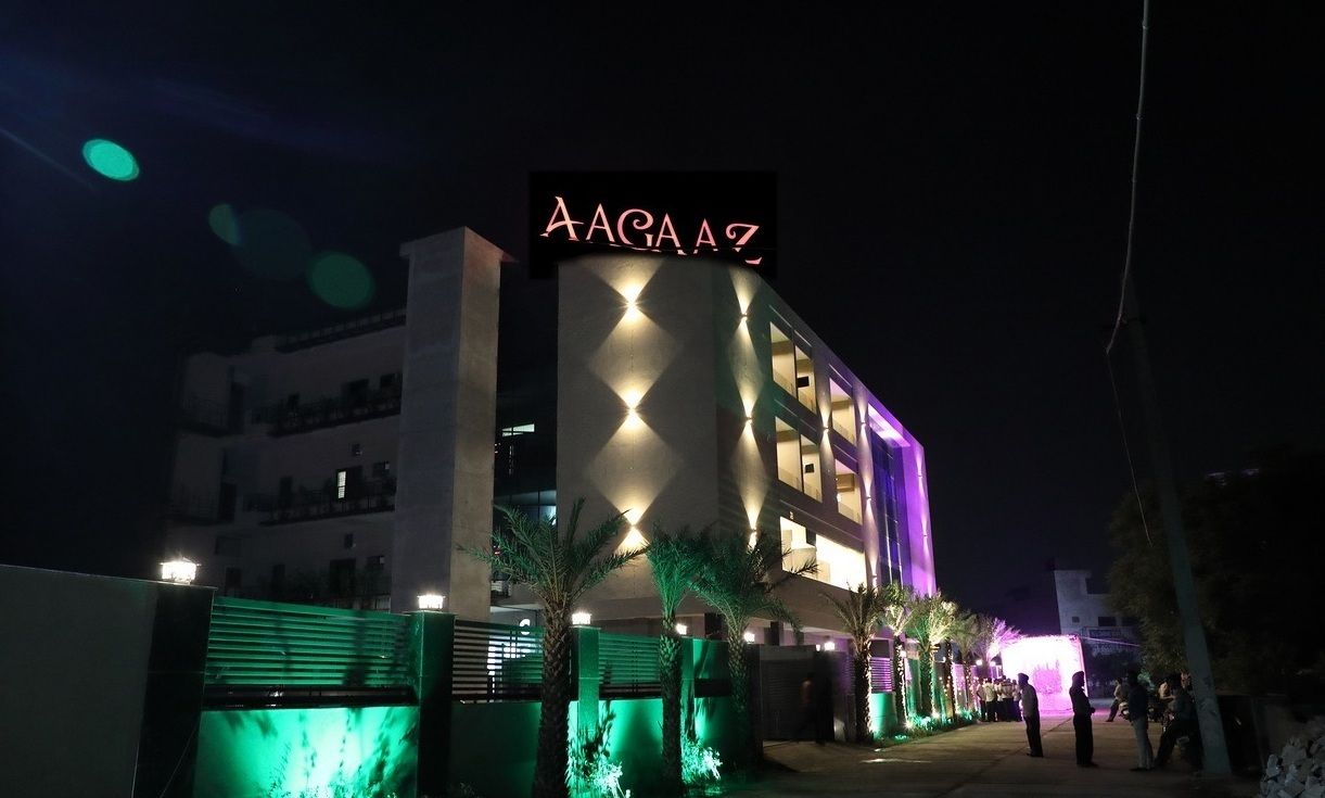 A building with a sign reading "AAGA AZ" at night.