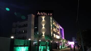 A building with a sign reading "AAGA AZ" at night.