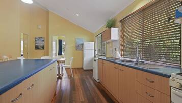 Full-size fridge, oven, stovetop, cookware/dishes/utensils