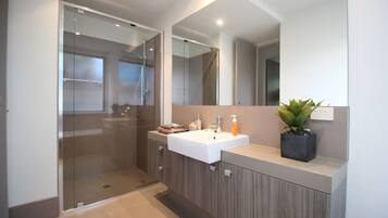 Separate bathtub and shower, towels