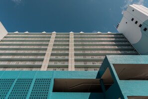 Experience the sleek, modern architecture of this high-rise building, featuring a grid-patterned balcony design.