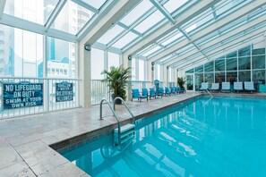 Relax by the pool surrounded by lounge chairs.