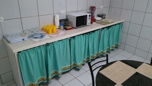 A kitchen with a microwave, coffee maker, and a small refrigerator. - House - Mar Condominium Azul (Porto de Galinhas)