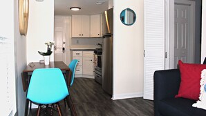 A compact living space with a dining area, kitchen, and a seating area. - Stylish Ocean Grove Apt - 4 Blocks from Beach & 2 Blocks from Downtown Asbury (Ocean Grove)
