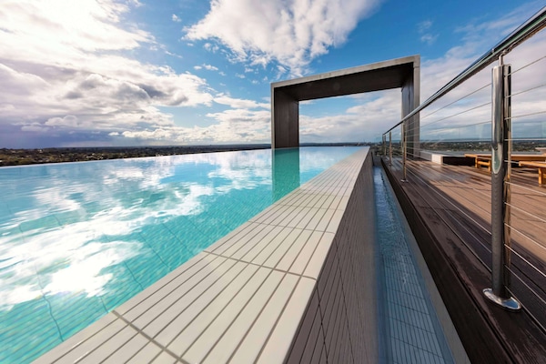 Outdoor pool, open 7:00 AM to 9:00 PM, pool loungers