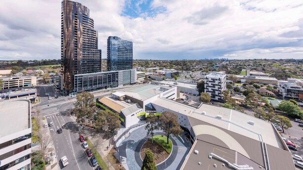 A modern urban area with high-rise buildings, a roundabout, and a mix of commercial and residential structures. - Avani Melbourne Box Hill Residences (Box Hill)