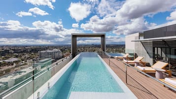 Outdoor pool, open 7:00 AM to 9:00 PM, pool loungers