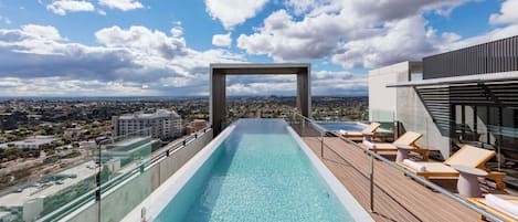 Outdoor pool, open 7:00 AM to 9:00 PM, pool loungers