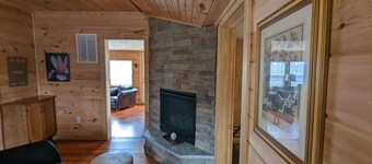 Ridgetop cabin featuring spa, sun room, fireplace and deck with panoramic views.