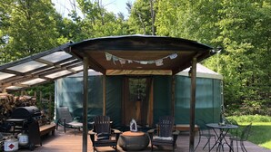 A covered outdoor area with a grill, seating, and a tent-like structure. - Totally secluded Yurt surrounded by waterfalls, brooks, cliffs and forest (Ulster Park)