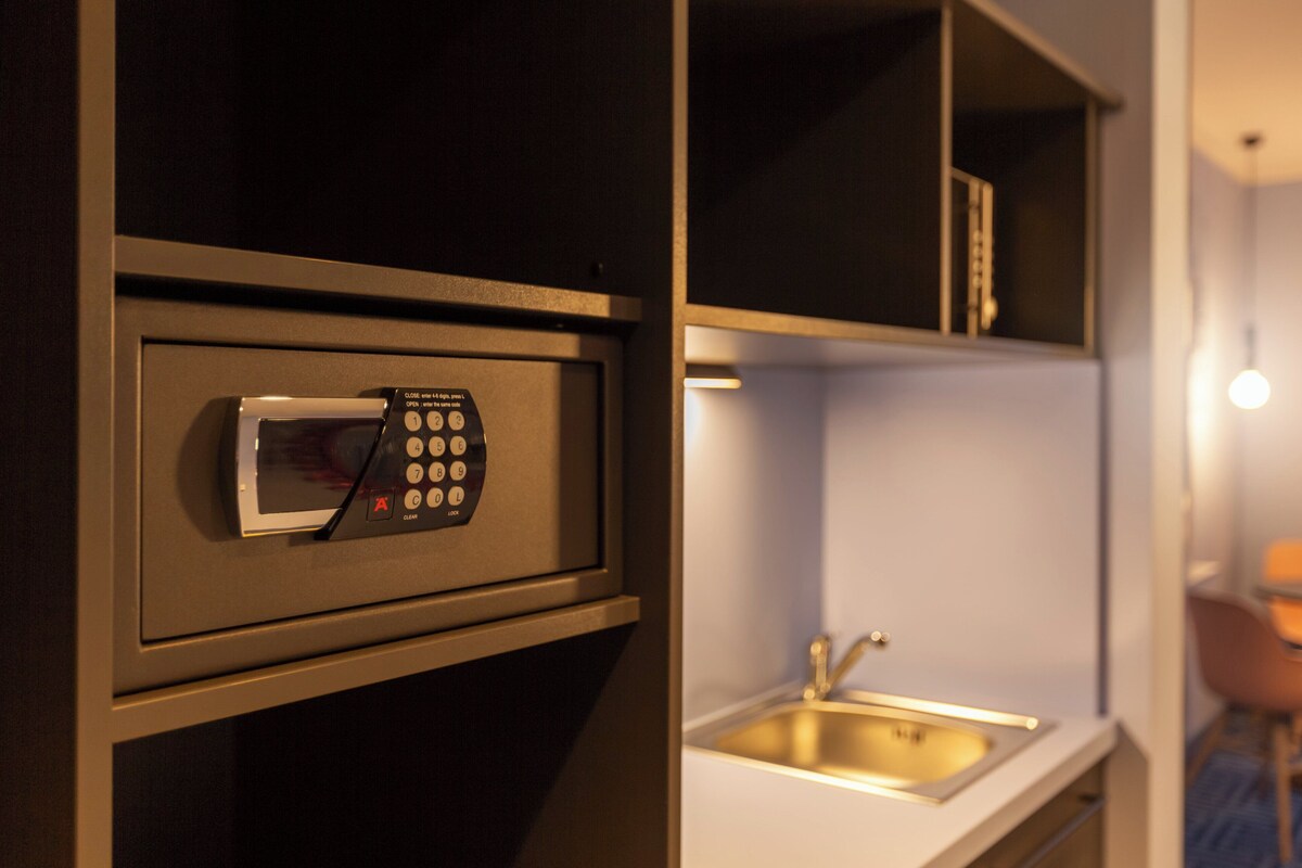 A kitchen with a built-in microwave, a sink, and a countertop.