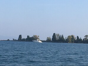 A large body of water with a yacht in the distance.