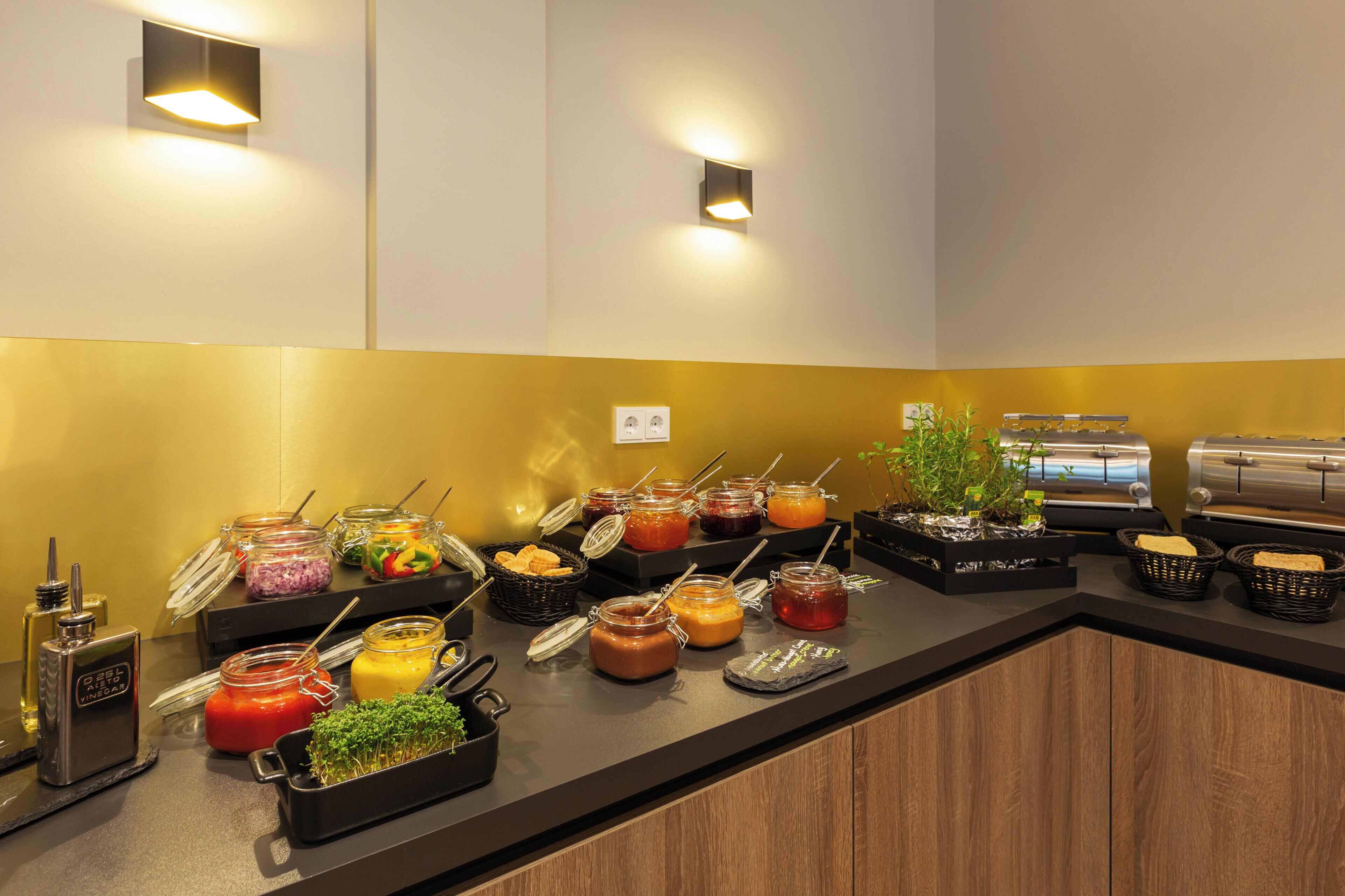A buffet setup with various food items and condiments.