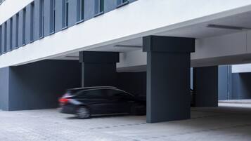 A modern building with a covered parking area.