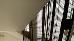 A staircase with a metal mesh partition. - Artemision (Athens)